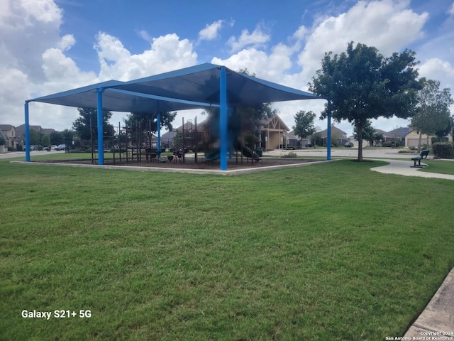 view of community featuring playground community and a yard