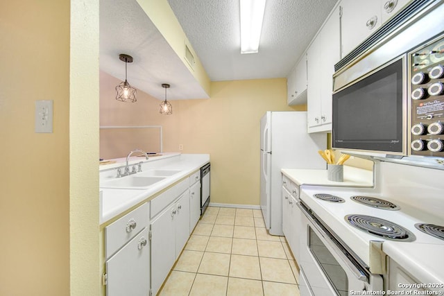 kitchen featuring light countertops, stainless steel microwave, a sink, a textured ceiling, and dishwashing machine