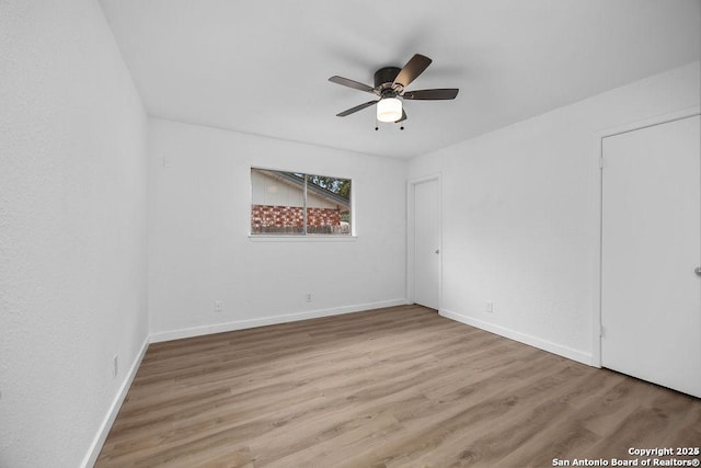 unfurnished bedroom with a ceiling fan, baseboards, and wood finished floors