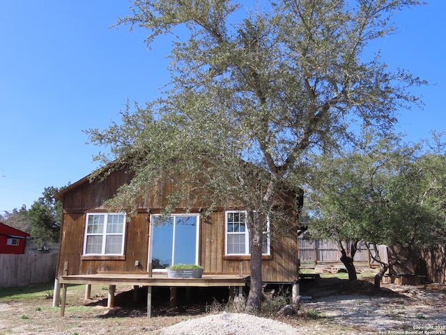 rear view of property with fence