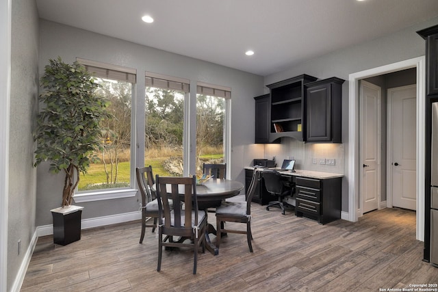 dining room with recessed lighting, baseboards, and wood finished floors