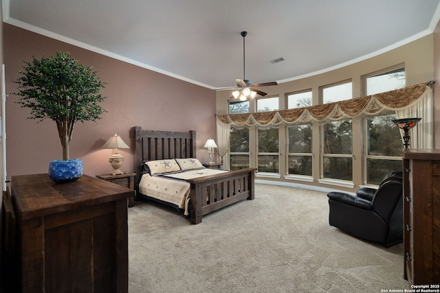 bedroom featuring carpet, visible vents, ceiling fan, and crown molding