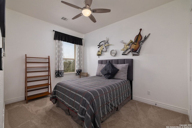 carpeted bedroom featuring a ceiling fan, visible vents, and baseboards