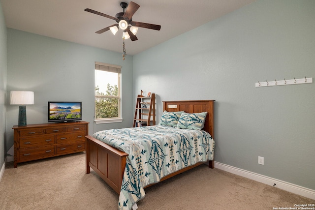 bedroom featuring light carpet, vaulted ceiling, a ceiling fan, and baseboards