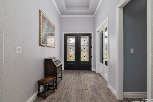 foyer with dark wood-type flooring, french doors, and baseboards