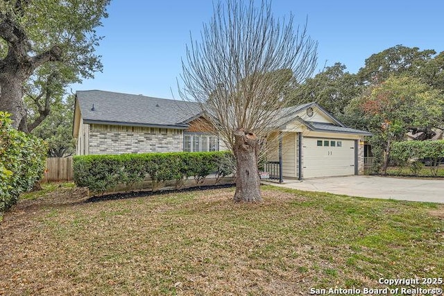 ranch-style home featuring a garage, driveway, a front yard, and brick siding