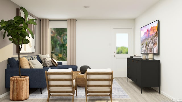 living area with light wood-style flooring and baseboards