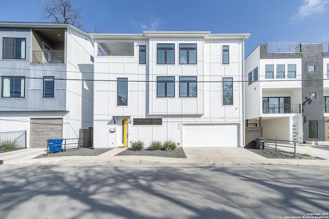 view of front of home featuring driveway, a garage, board and batten siding, and stucco siding