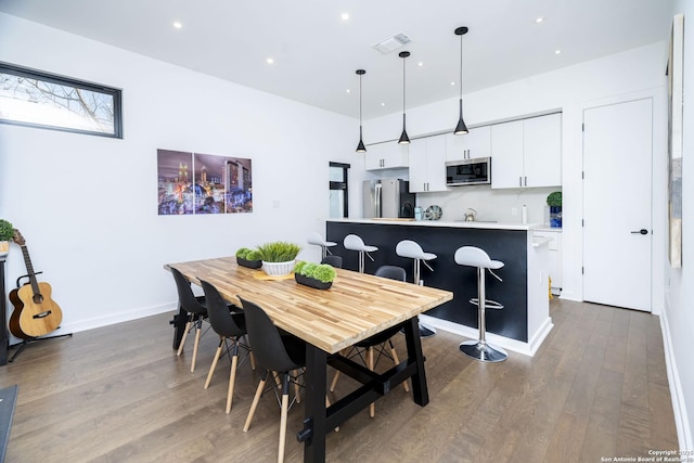306 S Mesquite St, San Antonio, TX 78203 - dining space featuring dark wood-style floors, baseboards, visible vents, and recessed lighting