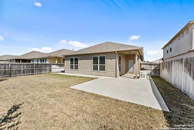 back of house featuring a patio area, a fenced backyard, and a yard