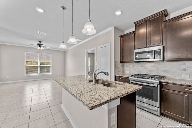 kitchen featuring tasteful backsplash, visible vents, appliances with stainless steel finishes, light tile patterned flooring, and a sink