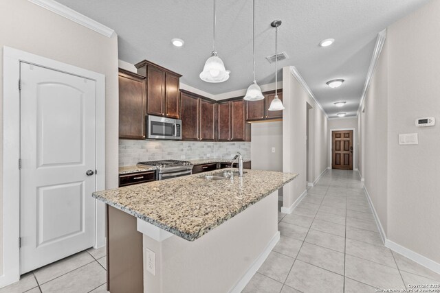 kitchen with light stone counters, stainless steel appliances, visible vents, light tile patterned flooring, and a sink