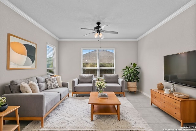 living room with ornamental molding, a ceiling fan, light tile patterned flooring, a textured ceiling, and baseboards