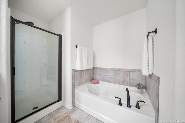 full bathroom featuring a stall shower and a garden tub