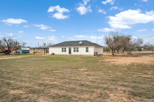 rear view of property featuring a yard