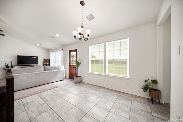 living area with lofted ceiling, baseboards, visible vents, and a chandelier