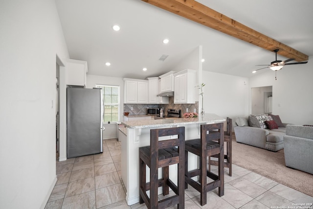 kitchen with lofted ceiling with beams, visible vents, white cabinetry, open floor plan, and appliances with stainless steel finishes