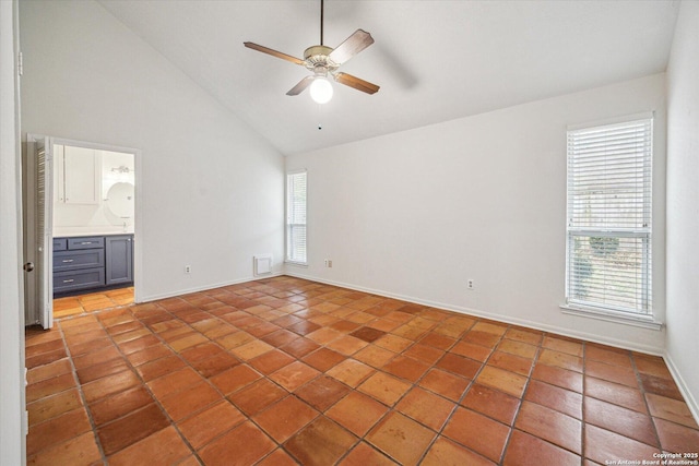 unfurnished bedroom with light tile patterned floors, visible vents, ceiling fan, high vaulted ceiling, and baseboards