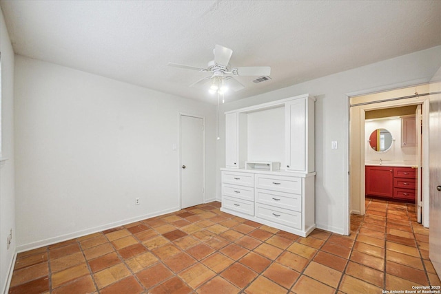 unfurnished bedroom featuring ceiling fan, a closet, visible vents, and baseboards