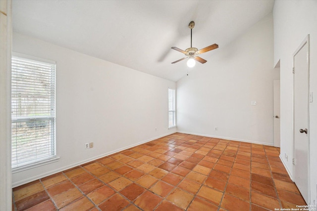 spare room with ceiling fan, high vaulted ceiling, light tile patterned flooring, and baseboards