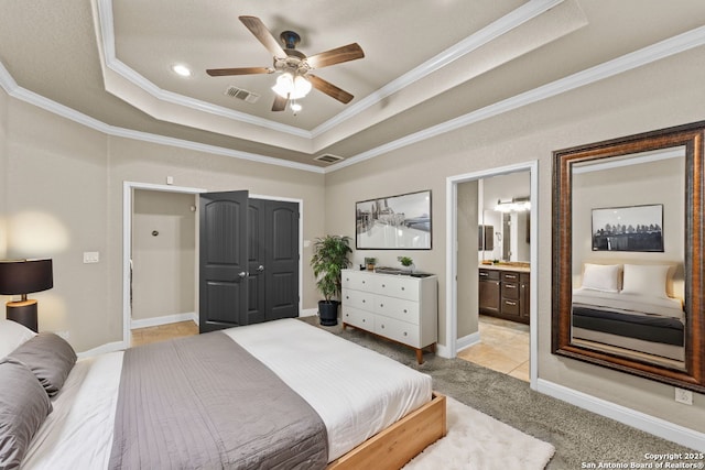 bedroom featuring ornamental molding, a tray ceiling, visible vents, and baseboards