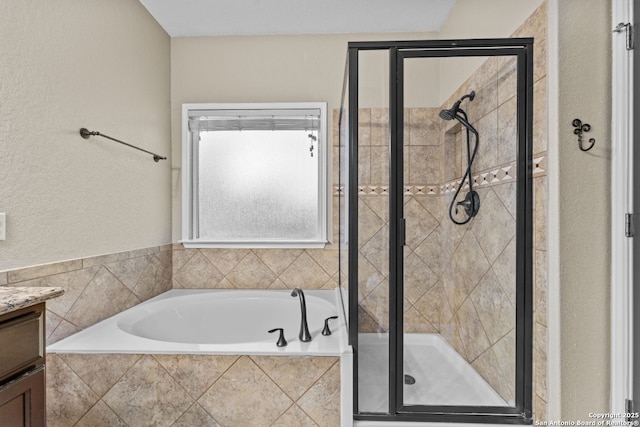 full bathroom featuring a shower stall, a bath, and vanity