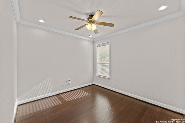 empty room with dark wood finished floors, crown molding, recessed lighting, ceiling fan, and baseboards