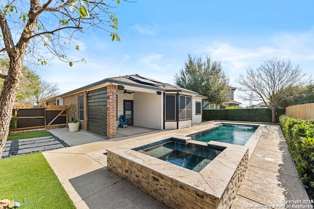 view of pool featuring a fenced backyard, ceiling fan, a gate, a patio area, and a pool with connected hot tub