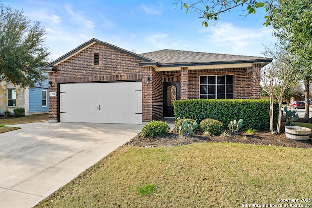 ranch-style house with a shingled roof, concrete driveway, an attached garage, a front lawn, and brick siding