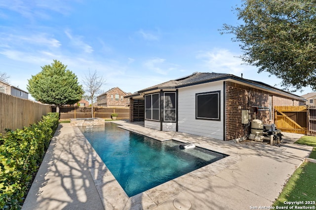 view of pool featuring an in ground hot tub, a fenced backyard, a fenced in pool, and a patio