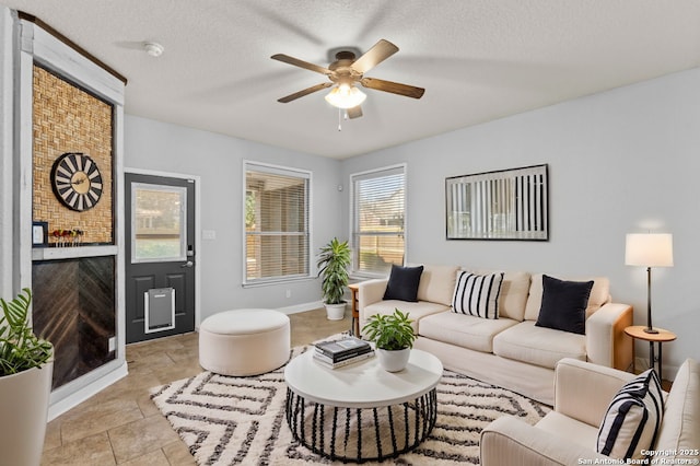 living room featuring a textured ceiling and a ceiling fan