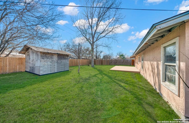 view of yard with an outbuilding, a shed, and a fenced backyard