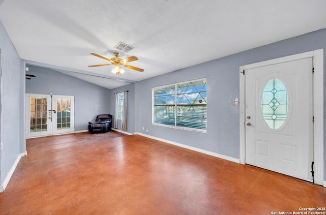 foyer featuring baseboards, visible vents, lofted ceiling, finished concrete floors, and french doors