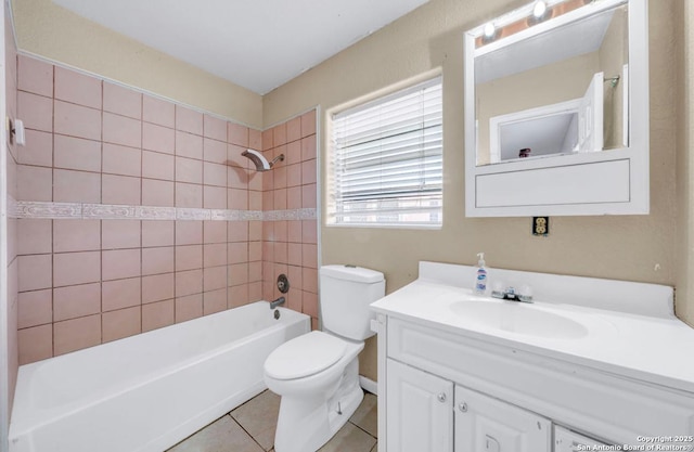 bathroom featuring toilet, shower / bathtub combination, vanity, and tile patterned floors