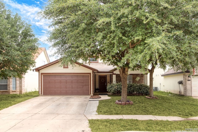 single story home featuring a garage, driveway, and a front yard