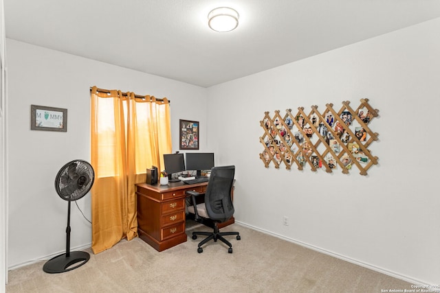 office with baseboards and light colored carpet