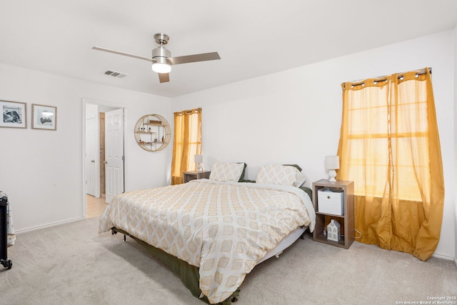 bedroom with carpet floors, visible vents, and a ceiling fan