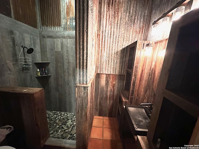 bathroom with a walk in shower and tile patterned floors