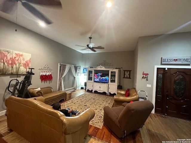 living room with a ceiling fan and wood finished floors