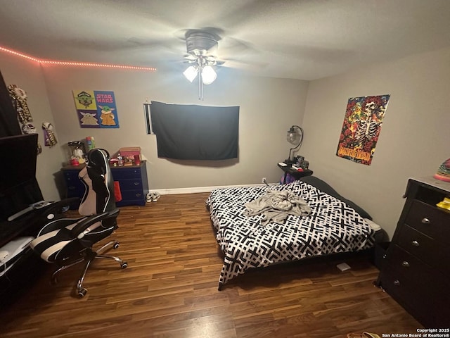 bedroom with ceiling fan and wood finished floors