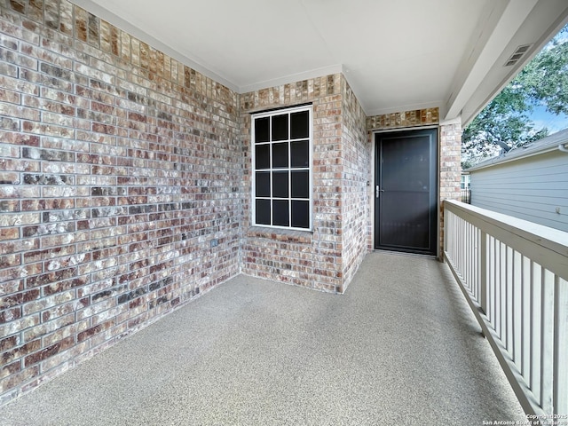 doorway to property with brick siding