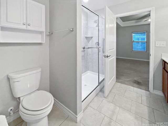 full bathroom with vanity, a shower stall, toilet, and baseboards