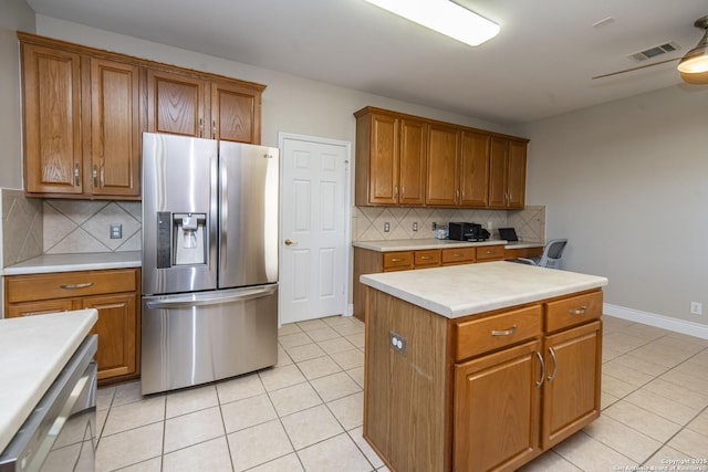 kitchen with brown cabinetry and stainless steel refrigerator with ice dispenser