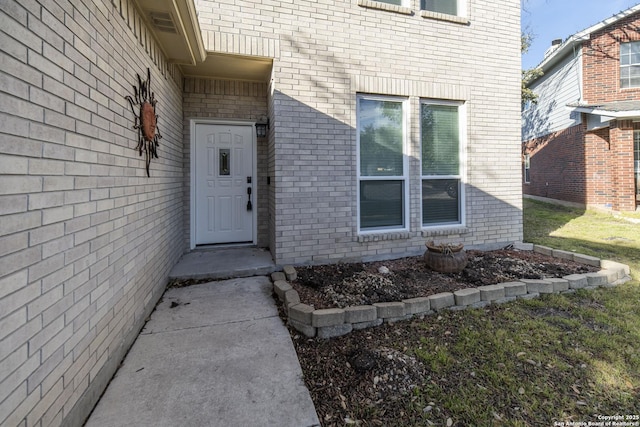 entrance to property with brick siding