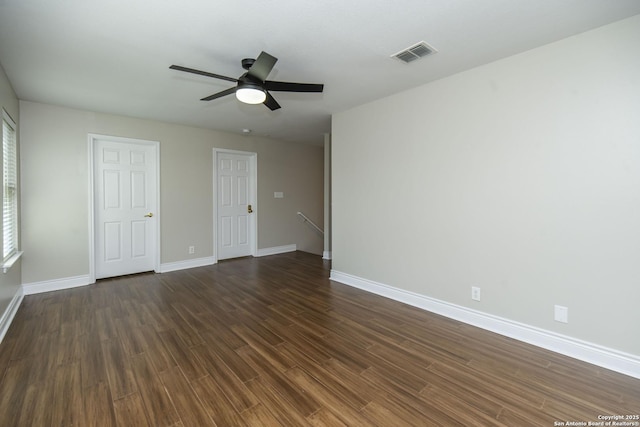 unfurnished bedroom featuring ceiling fan, dark wood-type flooring, visible vents, and baseboards