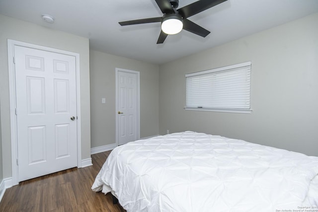 bedroom with ceiling fan, baseboards, and wood finished floors