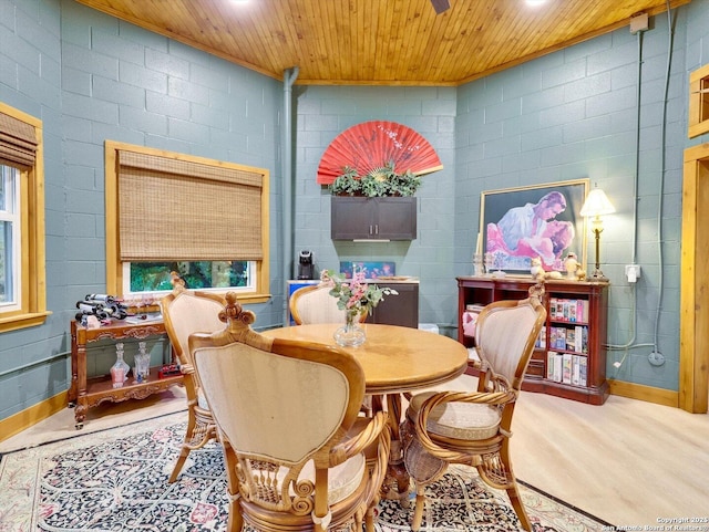 dining space featuring wood ceiling, crown molding, and wood finished floors