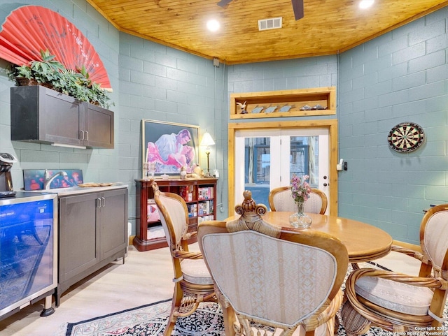 dining area with light wood finished floors, wood ceiling, visible vents, and recessed lighting