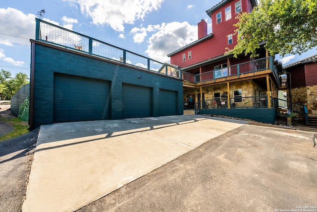 exterior space featuring a garage and a chimney