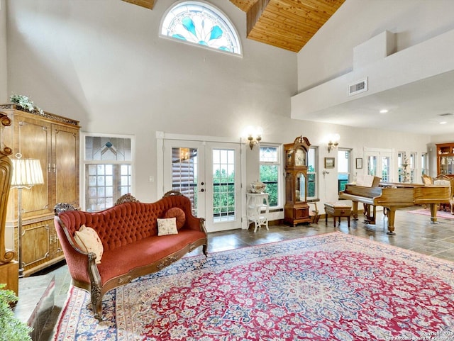 living area with high vaulted ceiling, french doors, wooden ceiling, and visible vents